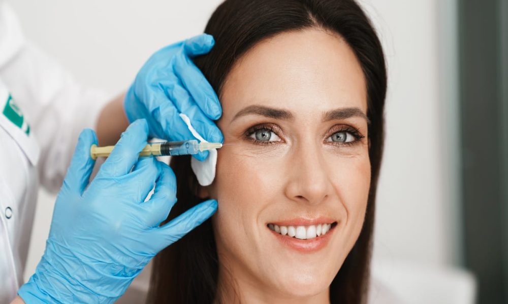 Beautiful face Botox injection Cosmetic skincare spa beauty treatment with blue gloves by eye, | Lily Med Spa in Dallas, Texas