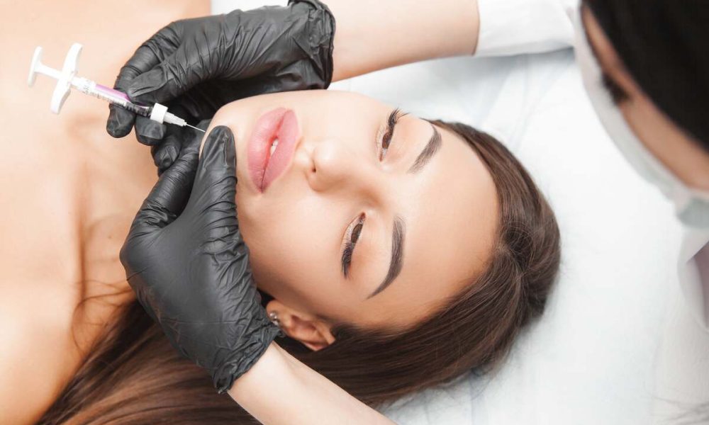 Cosmetologist does kybella therapy of a beautiful woman in a beauty salon. Cosmetology concept. | Lily Med Spa in Dallas, Texas